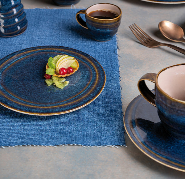 Ariane Splash Denim Coupe Plate in a styled table setting