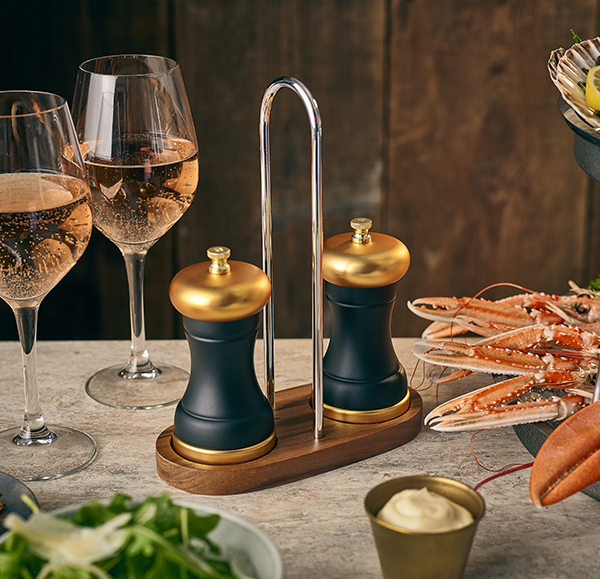 Genware acacia wood grinder stand in a table setting