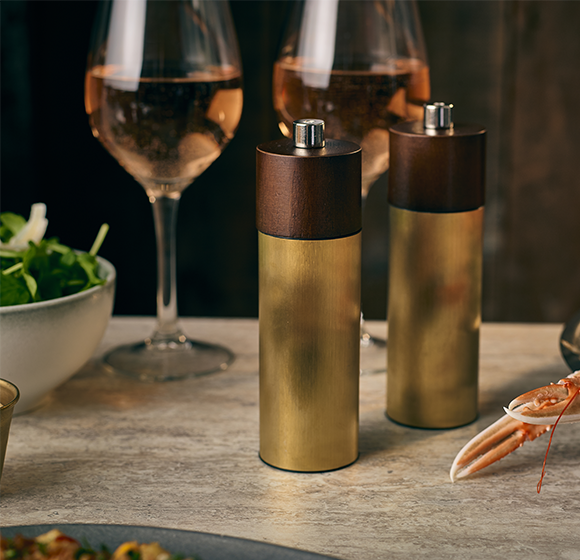 Genware Hackney gold salt and pepper grinder in a styled setting