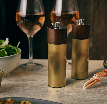 Genware Hackney gold salt and pepper grinder in a styled setting