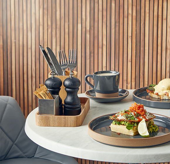 Genware black salt and pepper grinder in a table setting