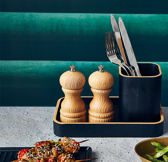 Genware light wood salt and pepper grinder in a table setting